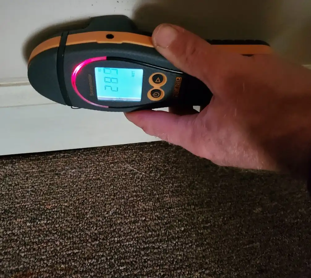 Moisture detection at baseboard during Storm Damage Restoration in Richland